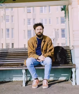 Charlie Battye seated on a bench